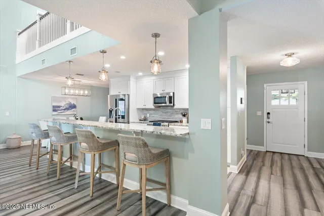 a bathroom with a granite countertop sink and a large mirror