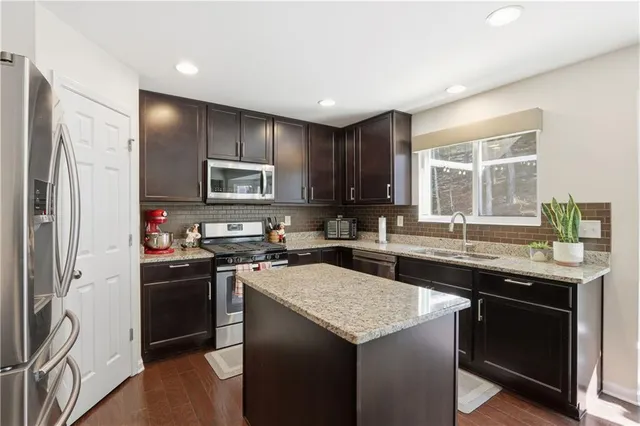 a kitchen with a sink stove and refrigerator