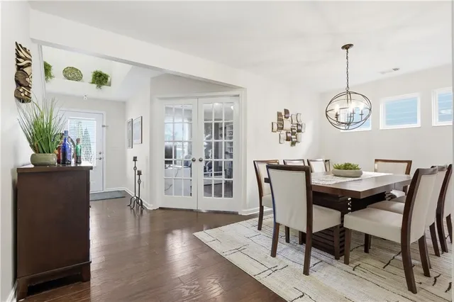 a view of a dining room with furniture wooden floor and a chandelier