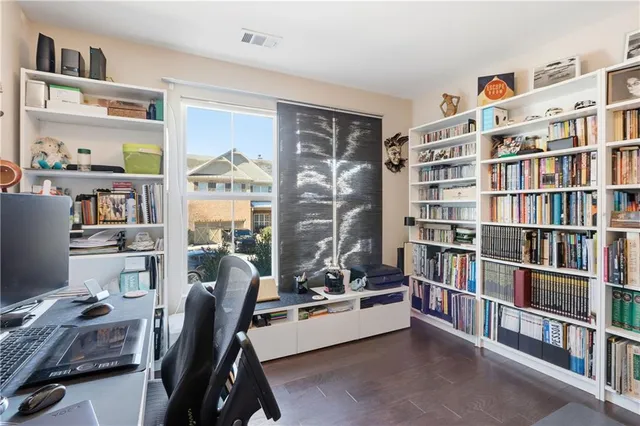 a view of a workspace with furniture and a bookshelf