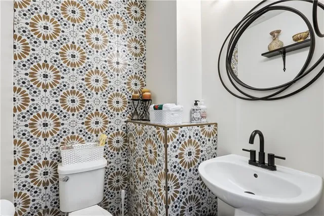 a bathroom with a sink a mirror and a shower curtain