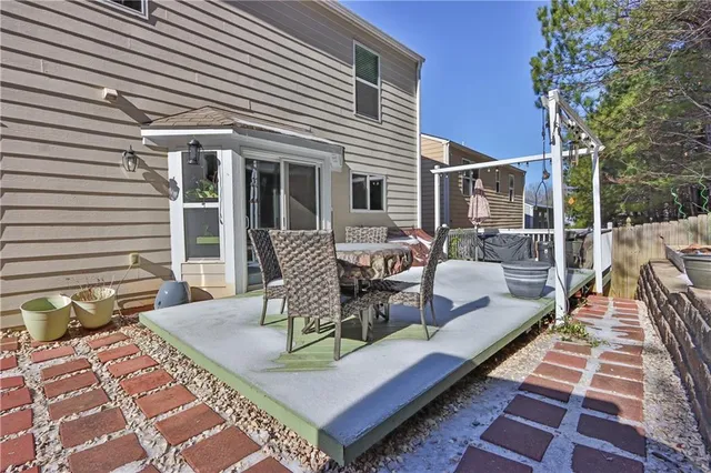 a view of a patio with a dining table and chairs