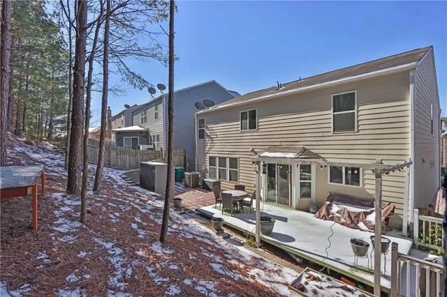 a view of a house with backyard and sitting area