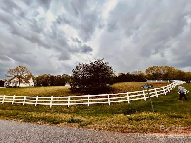a view of a swimming pool with an outdoor seating and a yard
