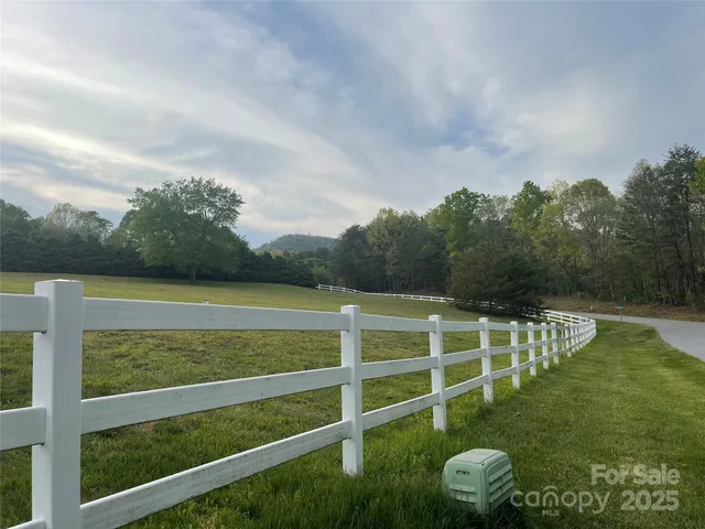 a view of a wooden fence with a big yard