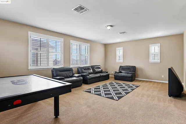 a living room with furniture rug and window