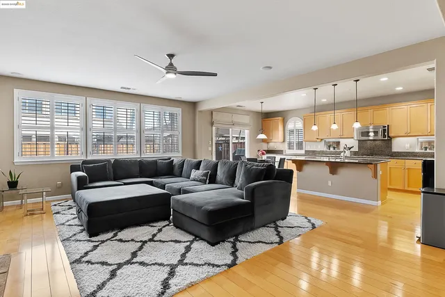 a living room with furniture and kitchen view