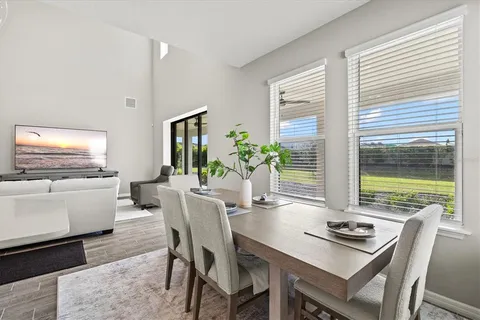 a living room with furniture and a view of kitchen