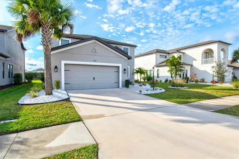 a front view of a house with a yard and garage