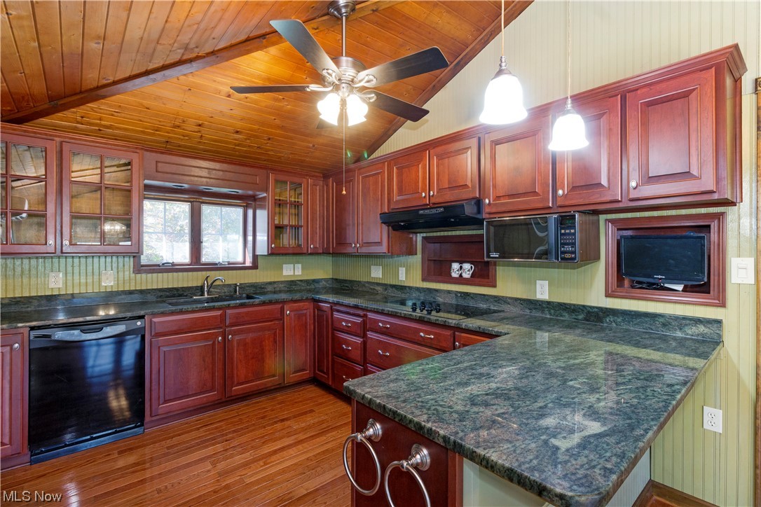 1224 Remsen Road Medina, OH 44256 - Photo 9 of 33 Kitchen with black appliances, pendant lighting, dark stone counters, lofted ceiling, wood ceiling, light hardwood floors, and ceiling fan