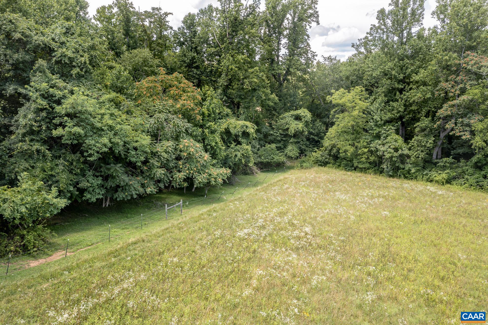11697 Spotswood Trail Ruckersville, VA 22968 - Photo 16 of 53 a view of a garden with a bench