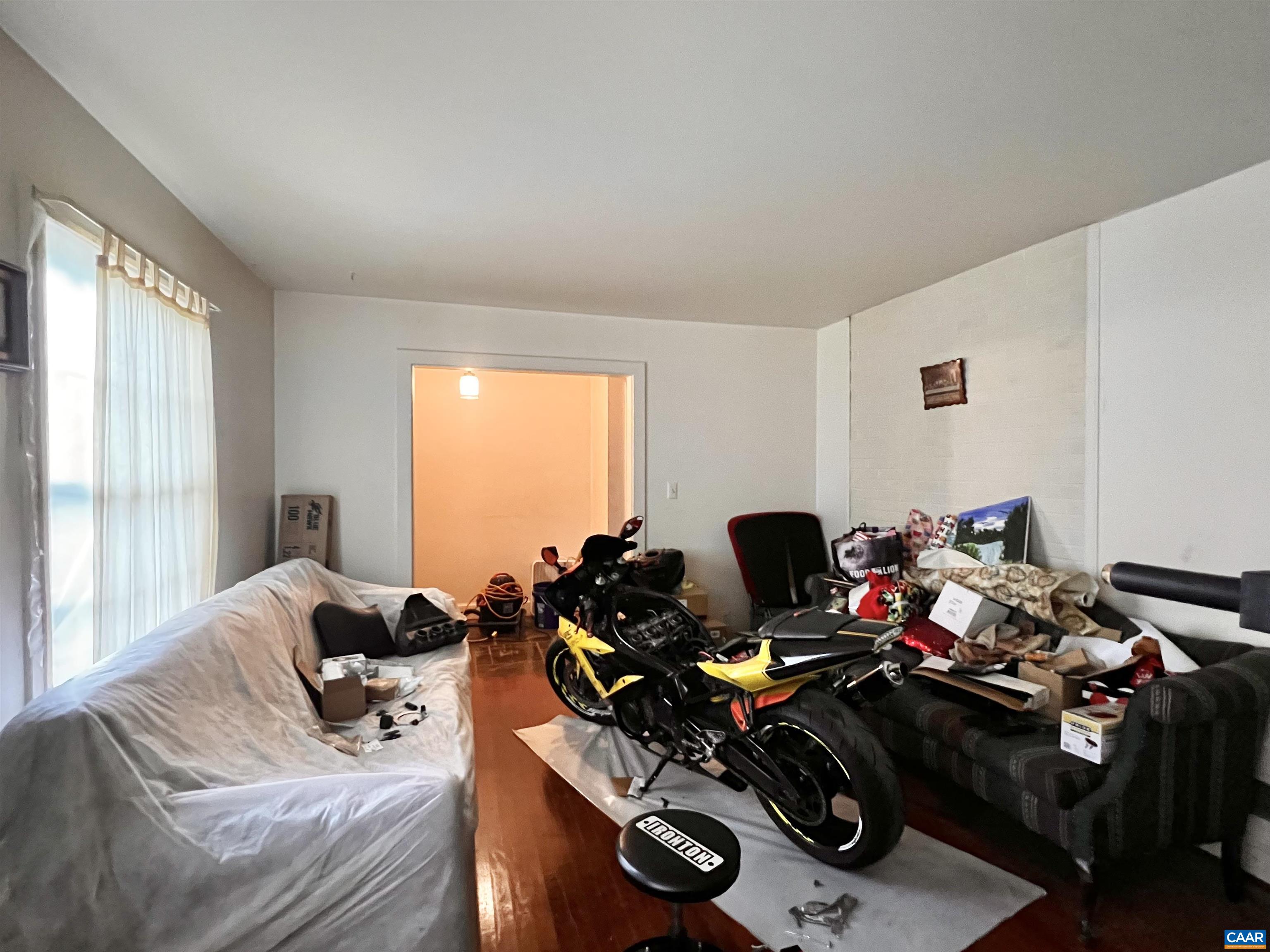 11697 Spotswood Trail Ruckersville, VA 22968 - Photo 37 of 53 a living room with furniture a window and gym equipment