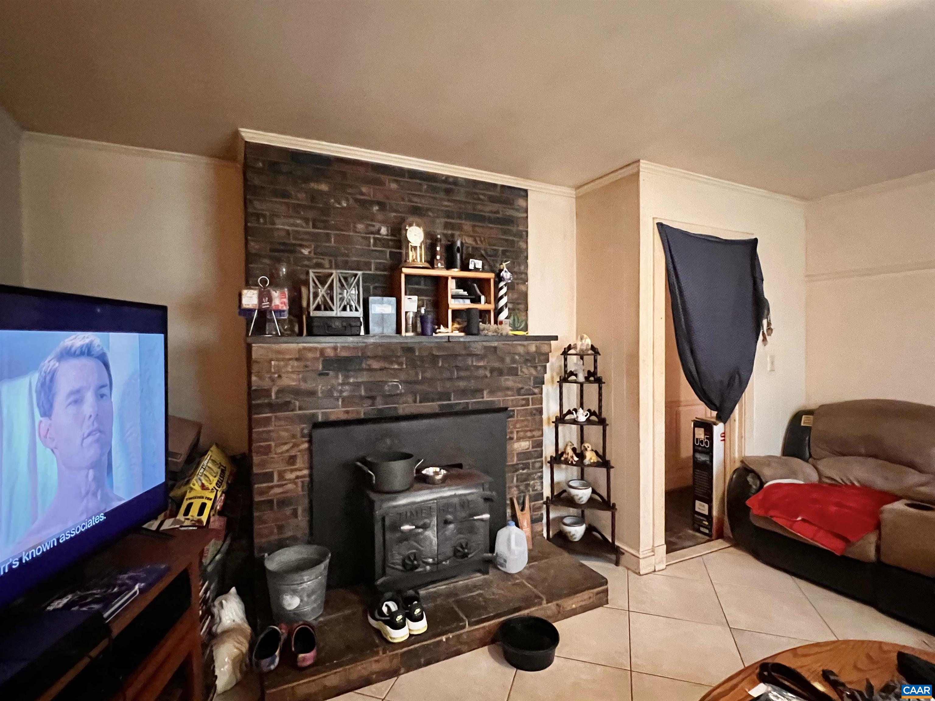 11697 Spotswood Trail Ruckersville, VA 22968 - Photo 39 of 53 a living room with furniture a flat screen tv and a fireplace