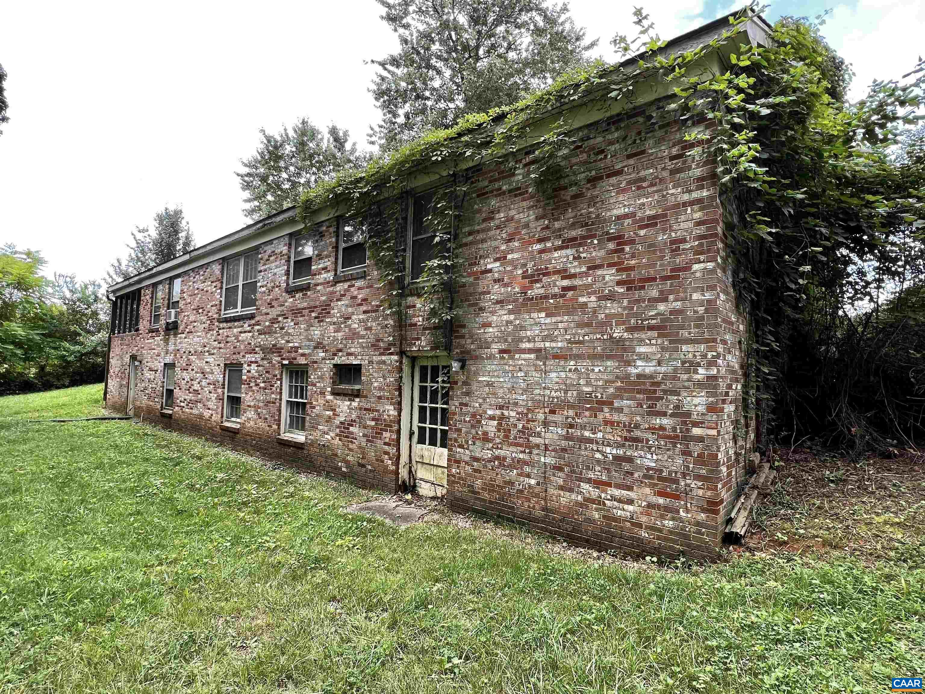 11697 Spotswood Trail Ruckersville, VA 22968 - Photo 42 of 53 a view of a wooden house with a yard