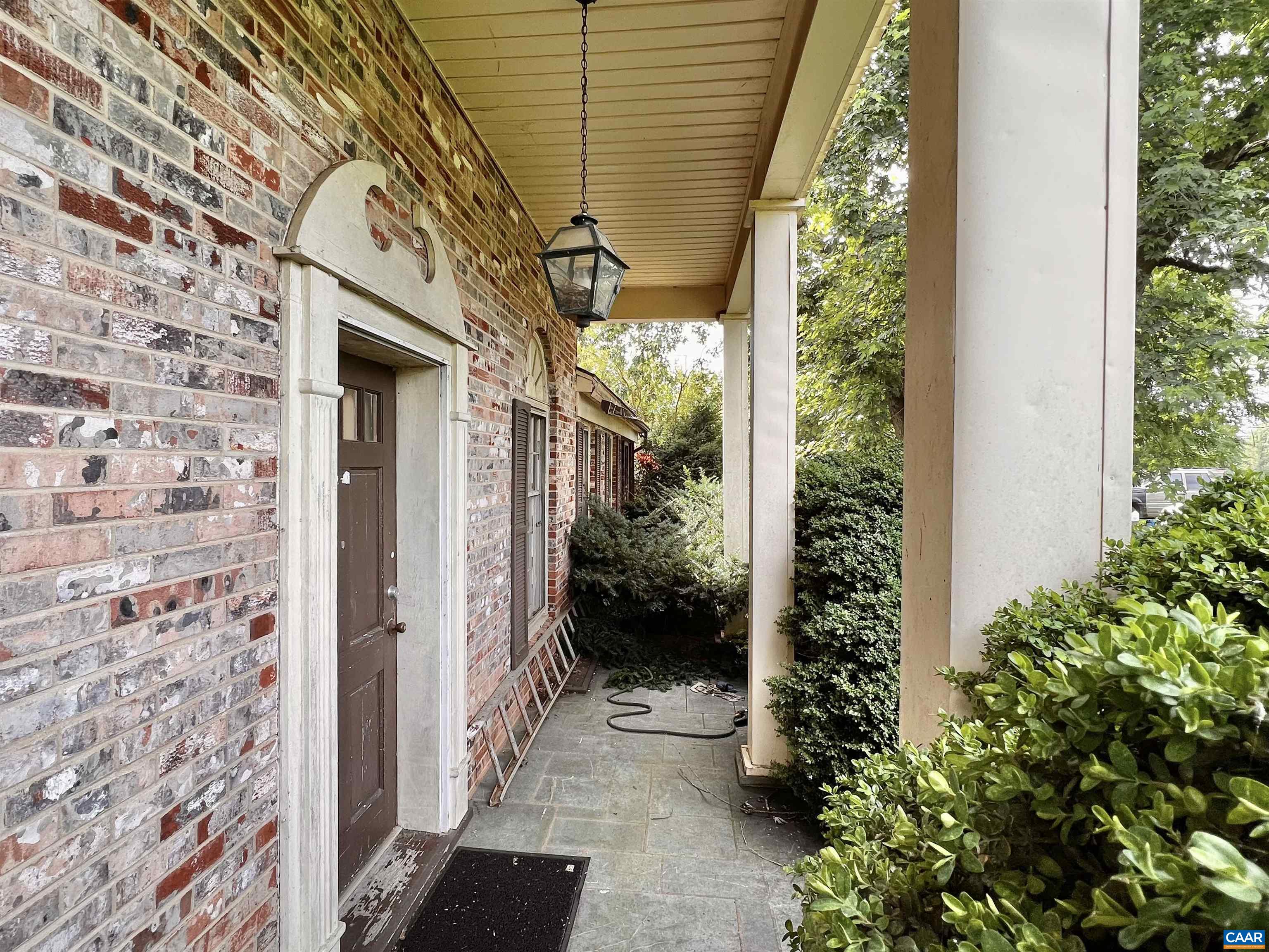 11697 Spotswood Trail Ruckersville, VA 22968 - Photo 45 of 53 a view of a pathway of a house with potted plants