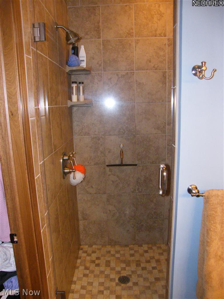 6838 Van Buren Road Clinton, OH 44216 - Photo 17 of 25 all tile walk in waterfall shower in the master on-suite bath
