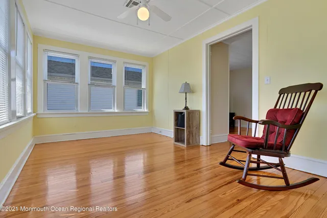 a view of a livingroom with furniture and hardwood floor
