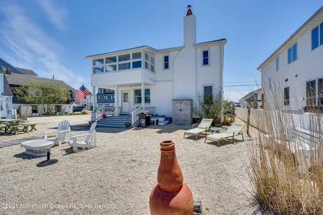 a front view of a building with cars parked