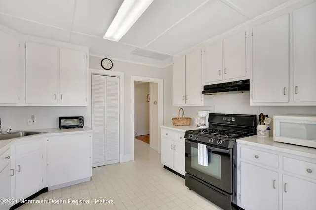 a kitchen with granite countertop cabinets and white appliances