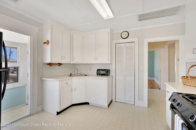 a view of a kitchen with cabinets and stainless steel appliances