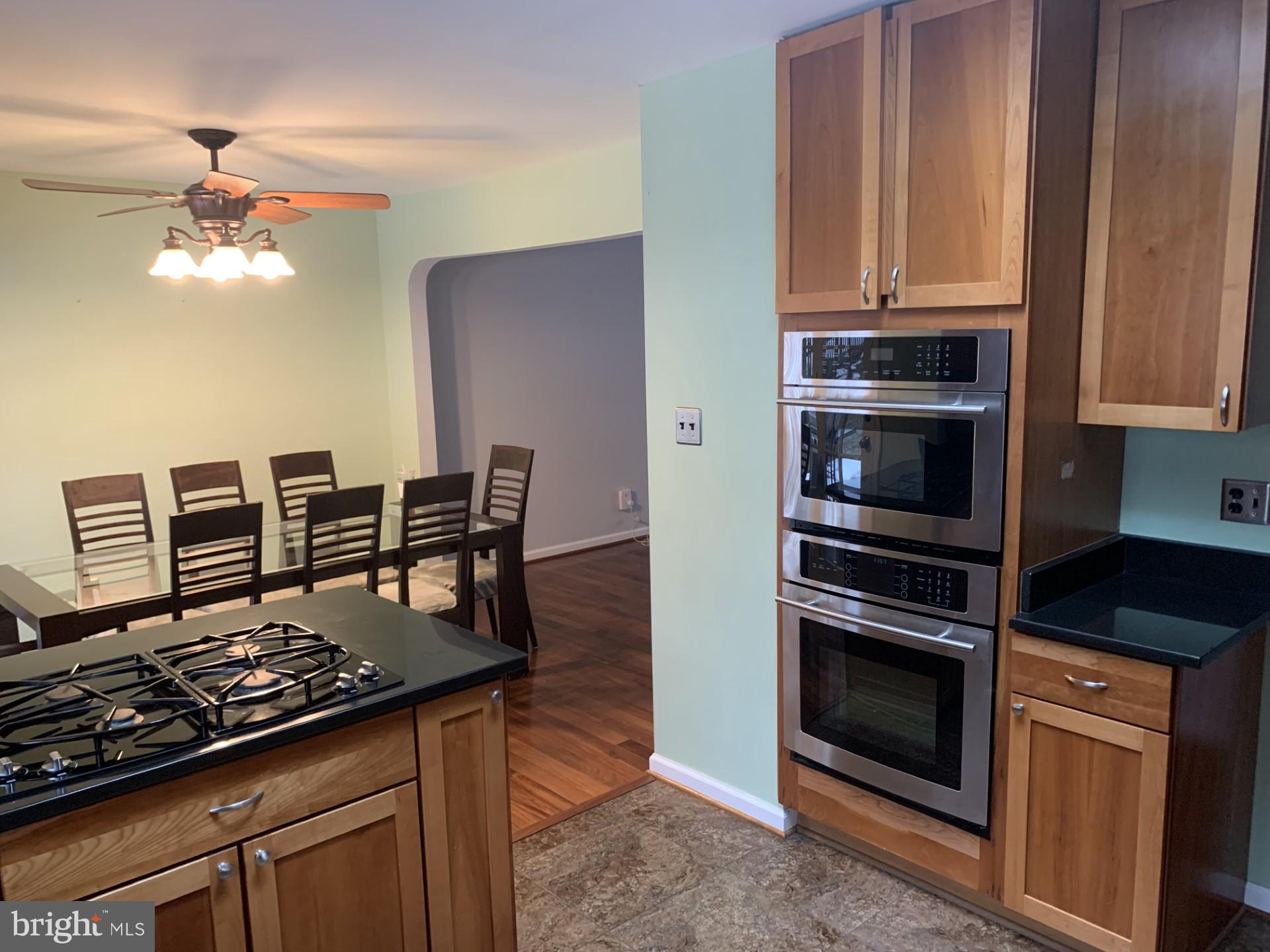 7004 Fitzpatrick Drive Laurel, MD 20707 - Photo 12 of 35 a kitchen with stainless steel appliances granite countertop a stove and a microwave