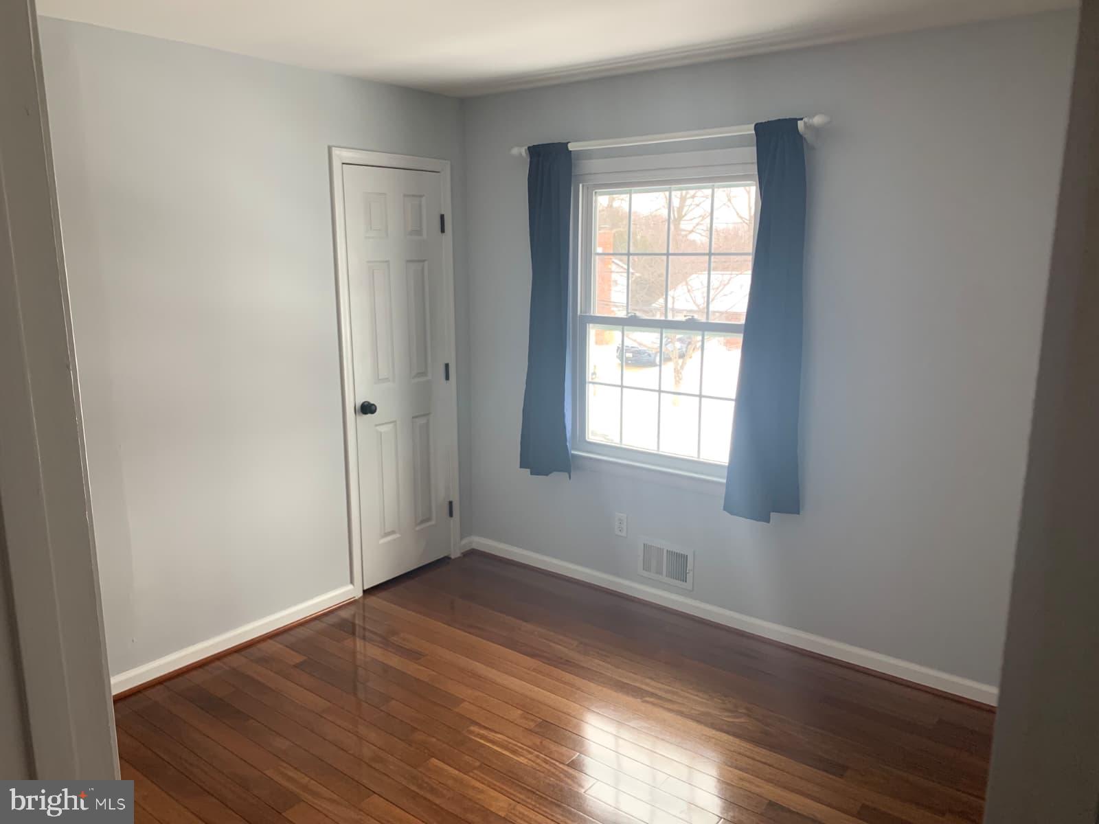 7004 Fitzpatrick Drive Laurel, MD 20707 - Photo 20 of 35 an empty room with wooden floor and windows