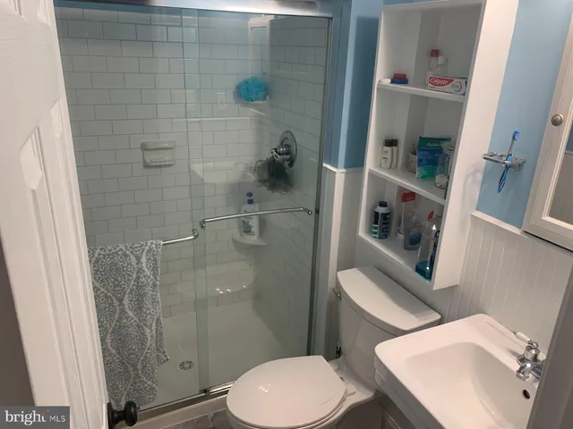 a white toilet sitting next to a bathroom sink