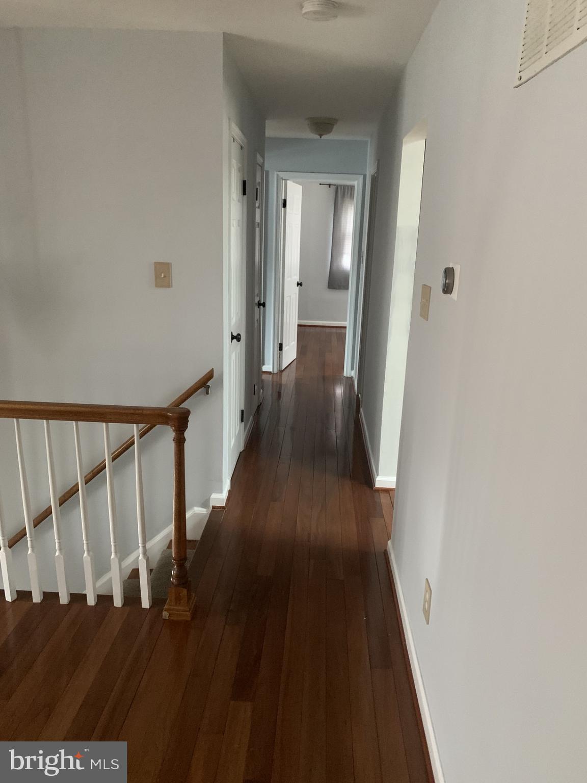 7004 Fitzpatrick Drive Laurel, MD 20707 - Photo 26 of 35 a view of a hallway with wooden floor and staircase