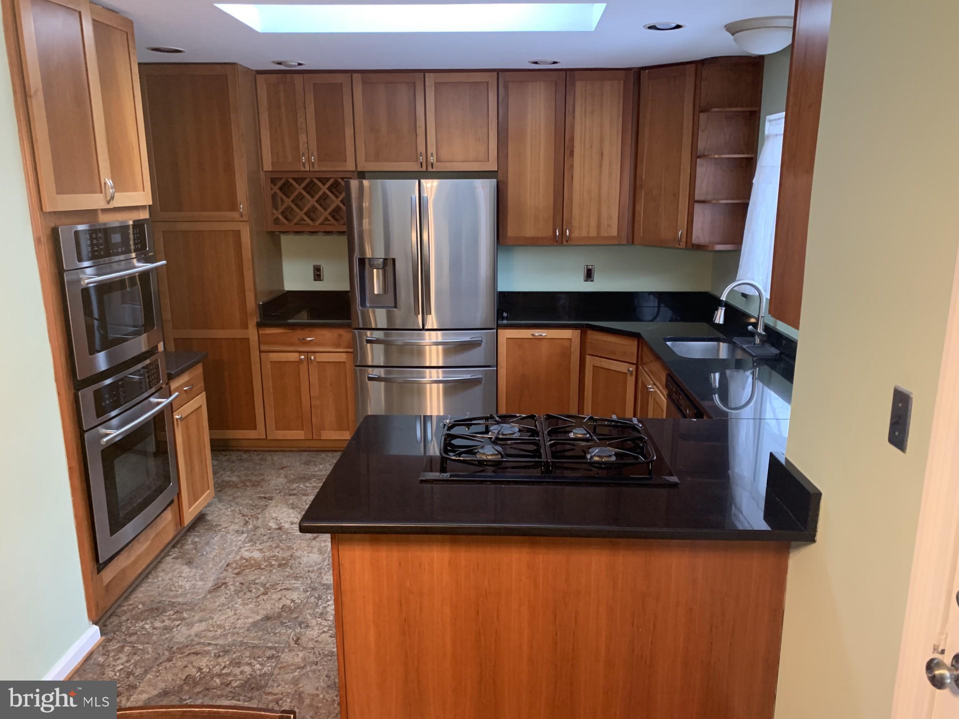 7004 Fitzpatrick Drive Laurel, MD 20707 - Photo 5 of 35 a kitchen with a refrigerator and a stove
