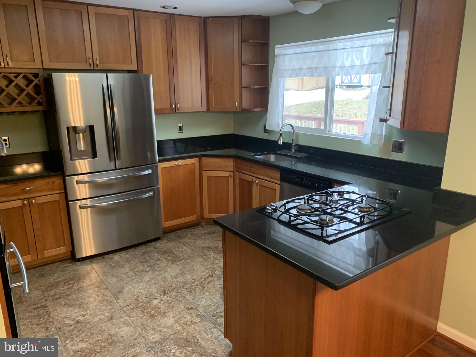 7004 Fitzpatrick Drive Laurel, MD 20707 - Photo 6 of 35 a kitchen with stainless steel appliances granite countertop a stove a refrigerator and a sink