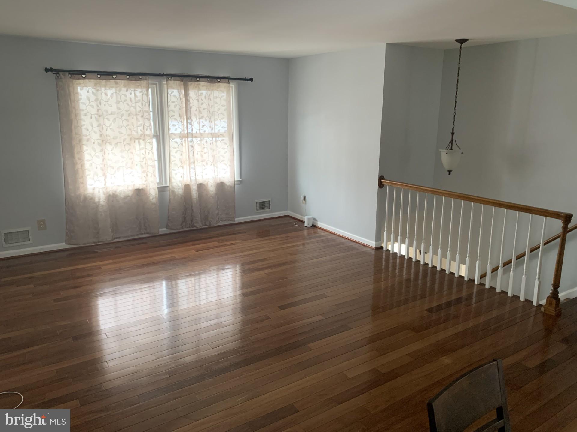 7004 Fitzpatrick Drive Laurel, MD 20707 - Photo 8 of 35 an empty room with wooden floor and windows