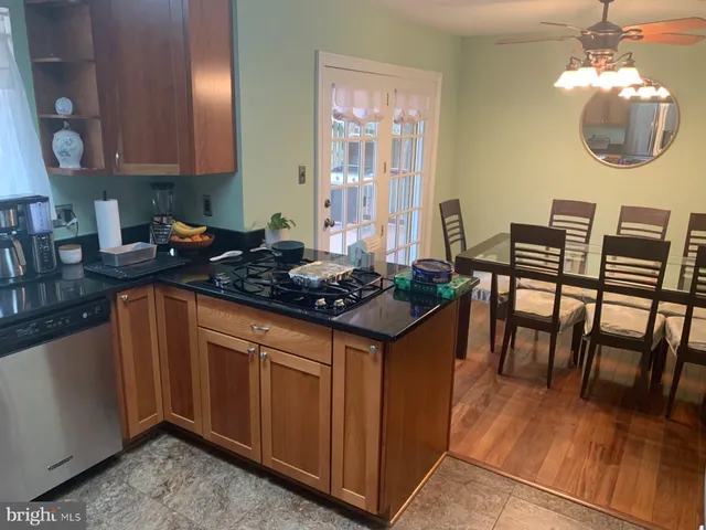 a kitchen with a table chairs stove and cabinets