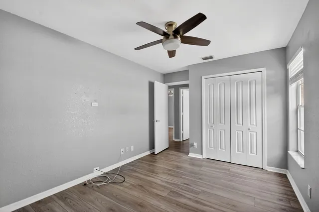 wooden floor in an empty room with a window