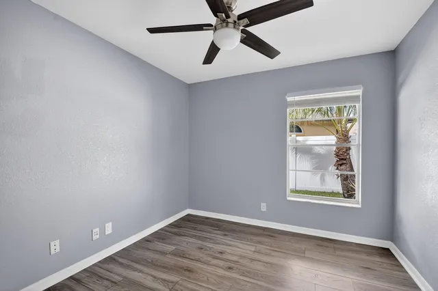 a bathroom with a toilet sink a mirror and vanity