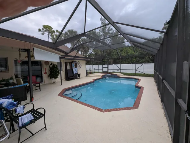 a view of a swimming pool with a patio