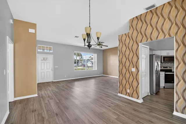 a view of an entryway with wooden floor