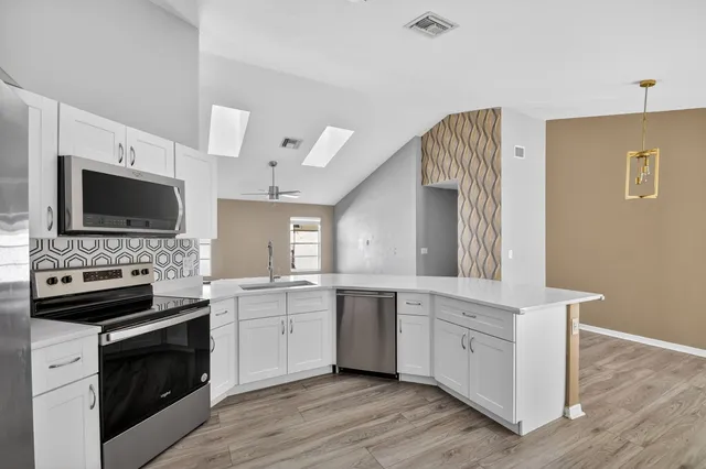 a kitchen with a sink stove and microwave