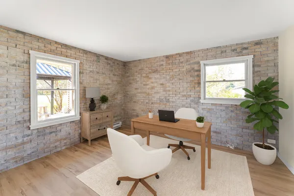 a workspace with furniture window and wooden floor