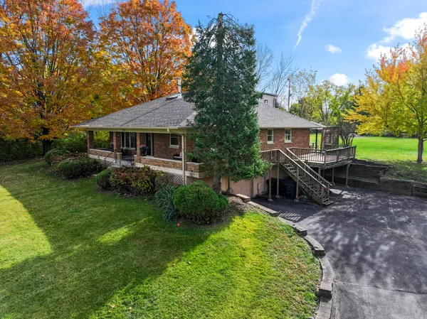 a view of a house with a backyard and a patio