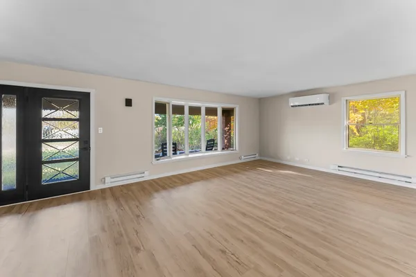 wooden floor in an empty room with a window