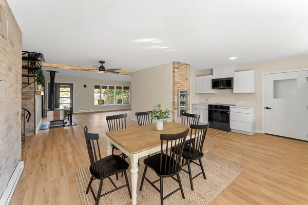 a view of a dining room with furniture and wooden floor