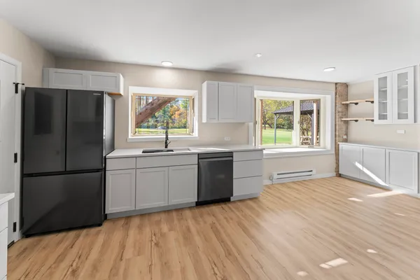 a kitchen with a refrigerator and a sink