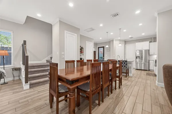 a dining room with furniture and wooden floor