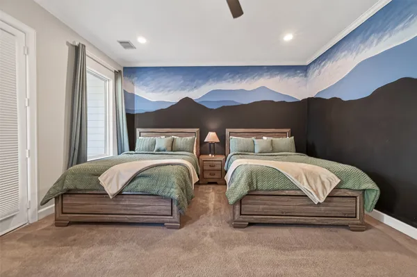 a spacious bedroom with a bed and a lamp