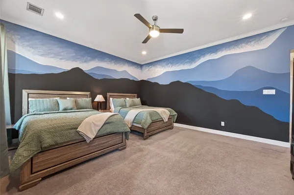 a spacious bedroom with a bed and a painting on the wall