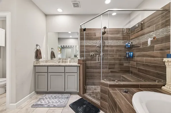 a bathroom with a shower sink and mirror