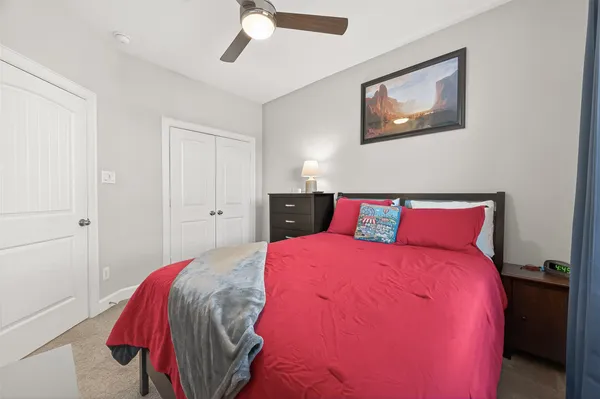 a bedroom with a bed and a painting on the wall