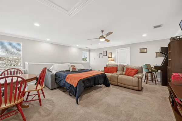 a spacious bedroom with a bed and a chandelier