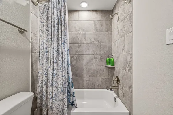 a bathroom with a bathtub and shower