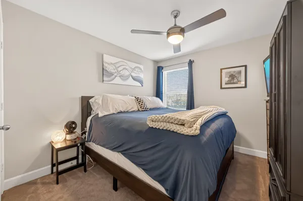 a bedroom with a bed and a chandelier
